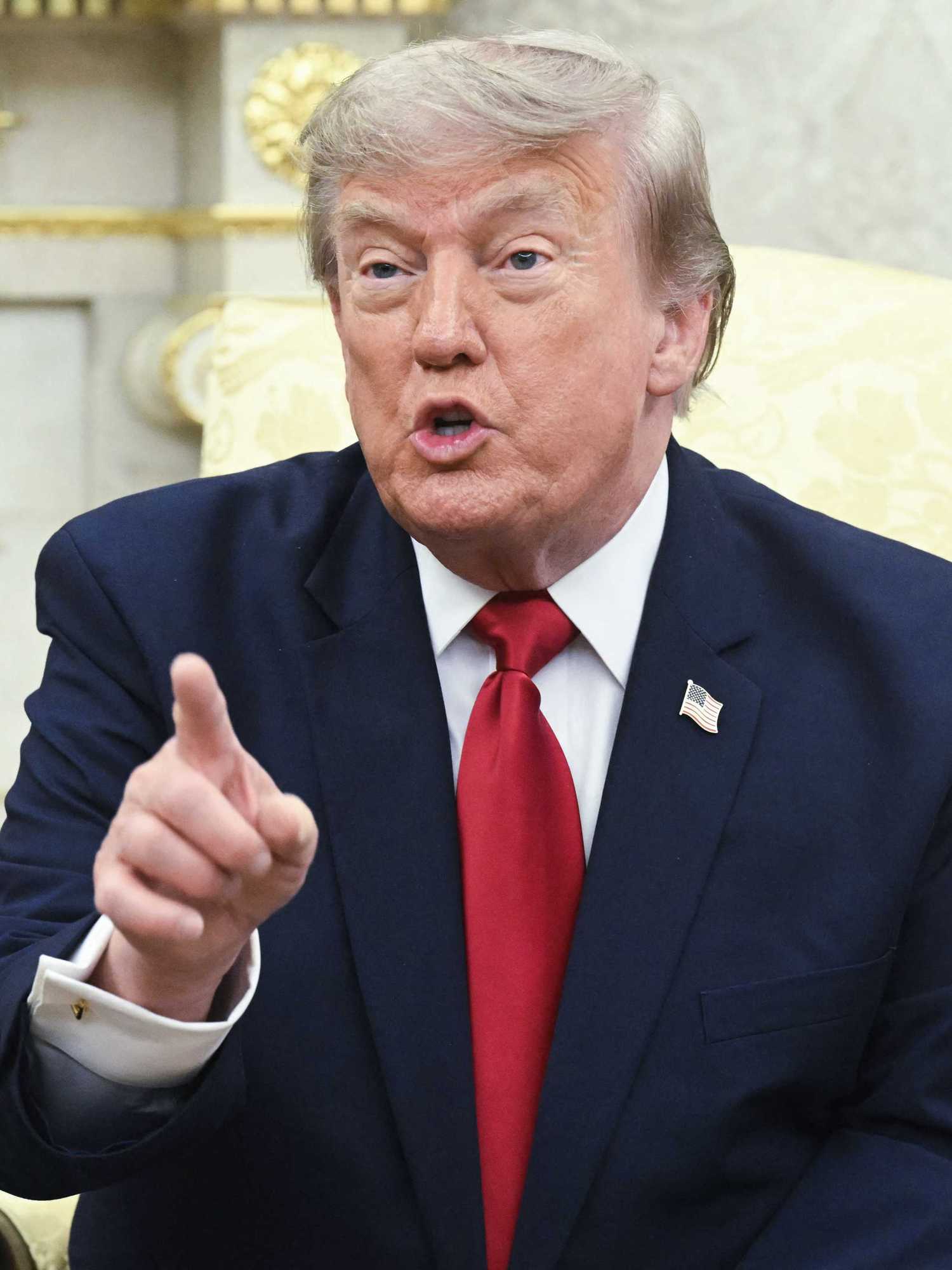 Donald Trump talking to reporters inside the Oval Office.