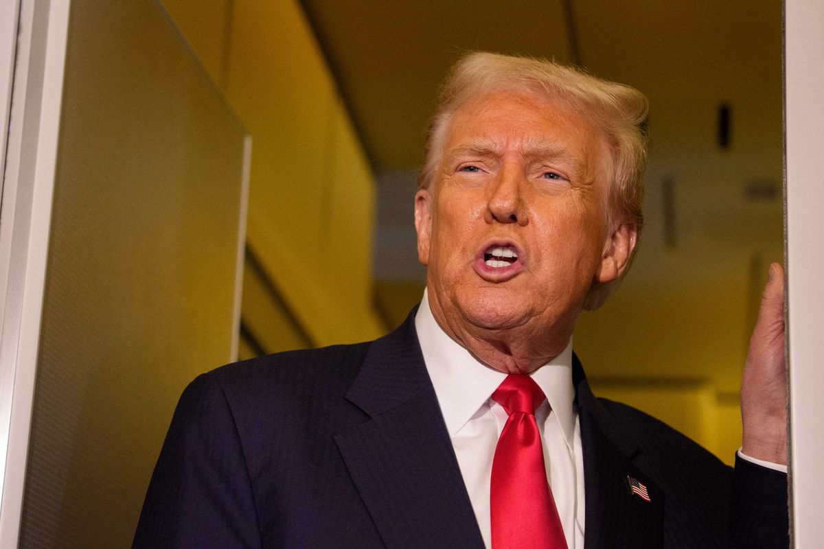 Donald Trump talking to reporters (off-camera) inside Air Force One.