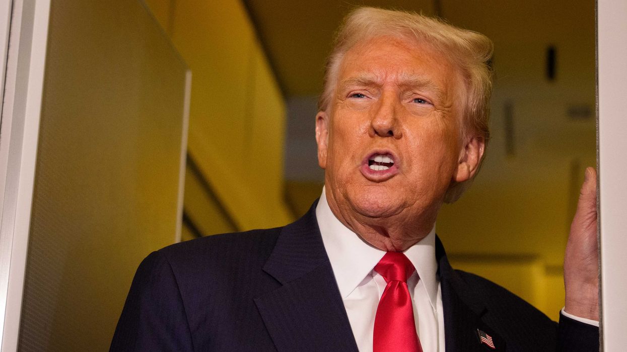 Donald Trump talking to reporters (off-camera) inside Air Force One.