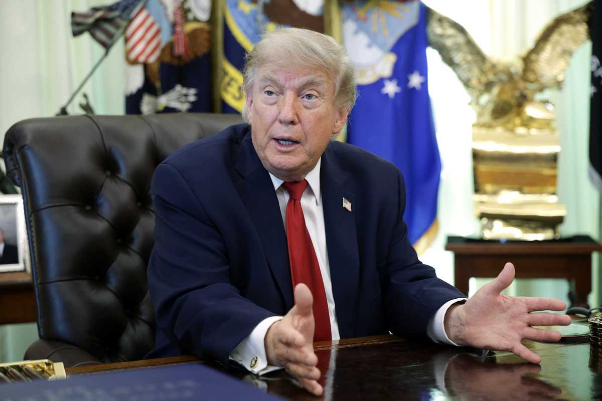 Donald Trump talks to reporters in the Oval Office.