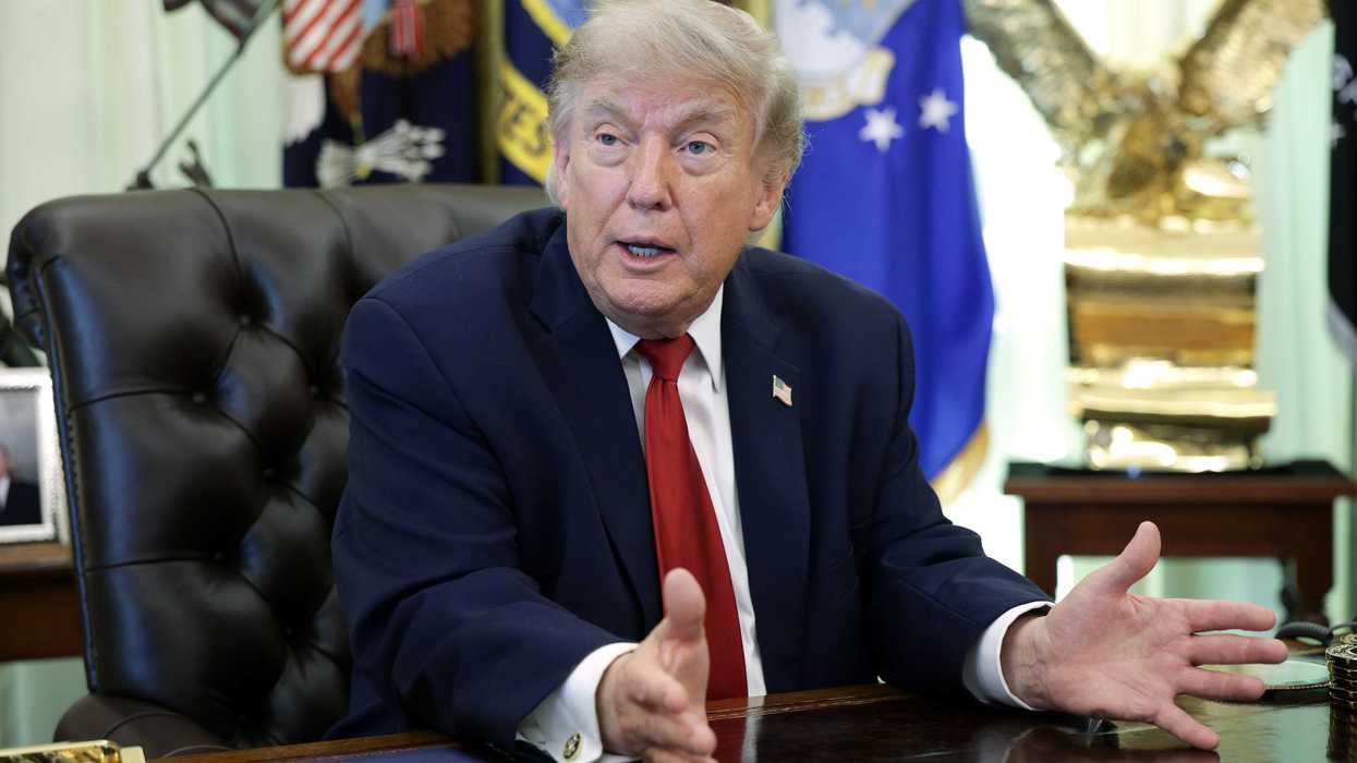 Donald Trump talks to reporters in the Oval Office.