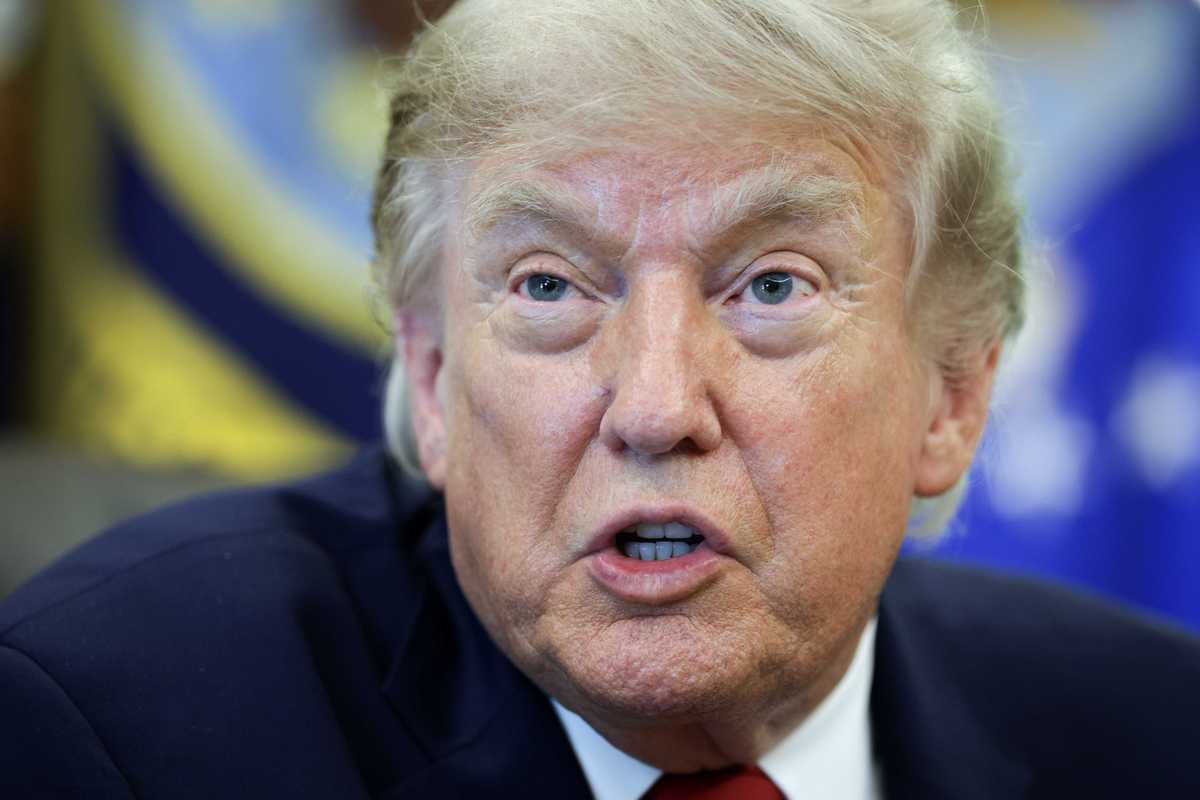 Donald Trump talks to reporters inside the Oval Office.