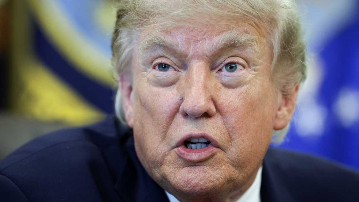 Donald Trump talks to reporters inside the Oval Office.