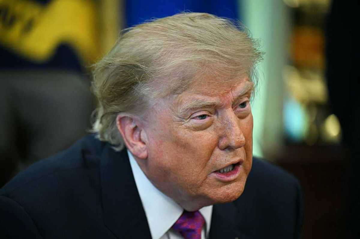 Donald Trump talks to reporters inside the Oval Office.