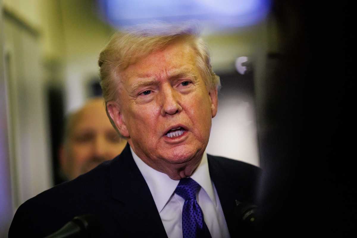 Donald Trump talks to reporters on Air Force One.