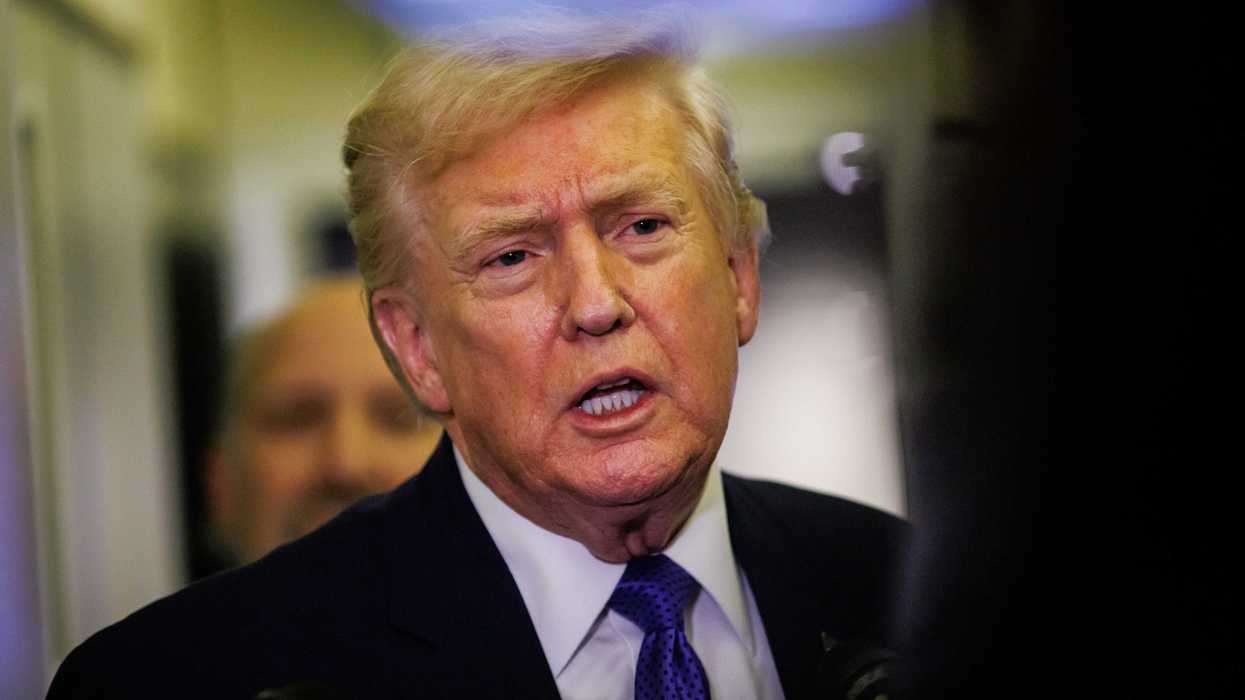 Donald Trump talks to reporters on Air Force One.