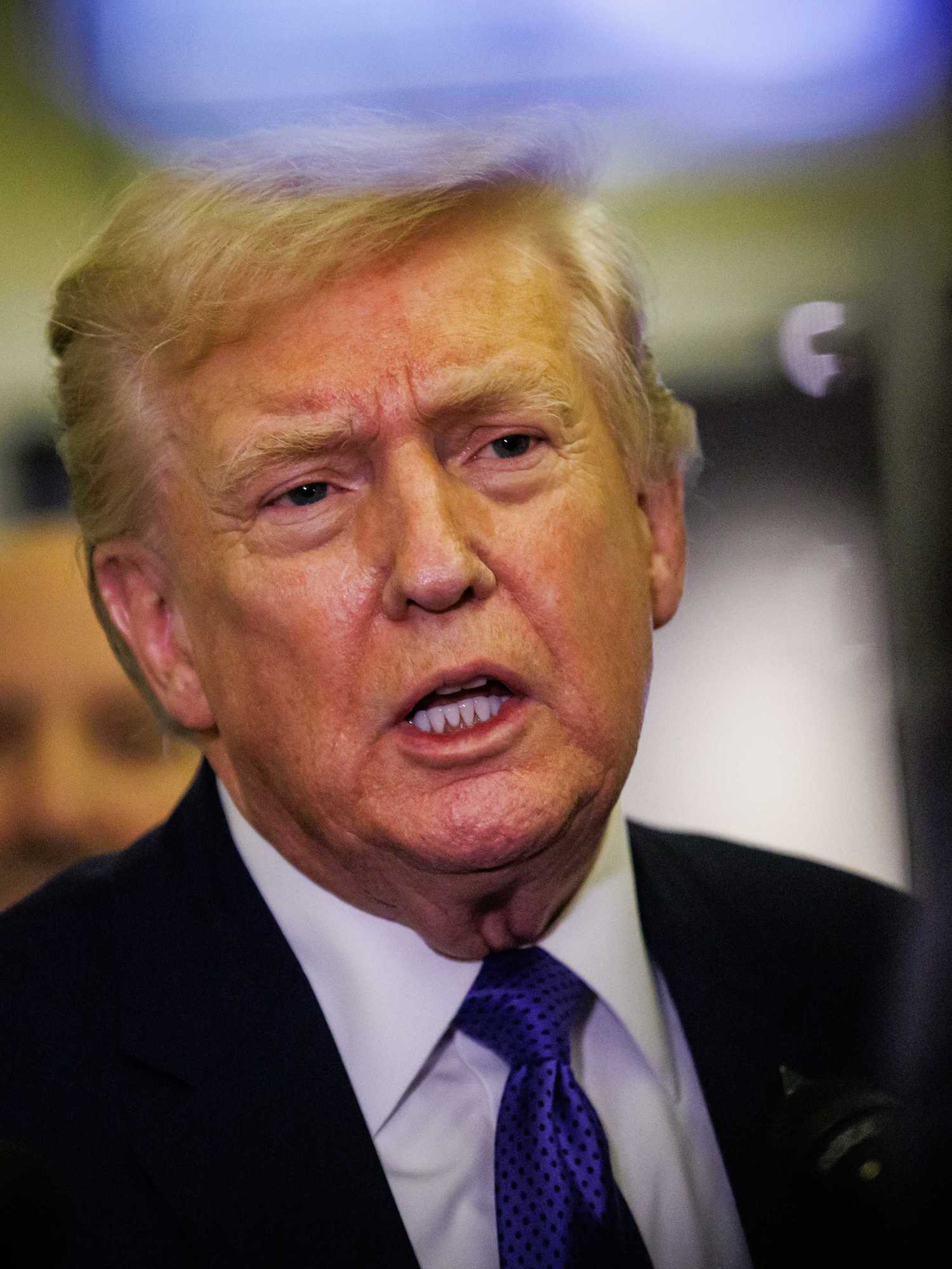 Donald Trump talks to reporters on Air Force One.