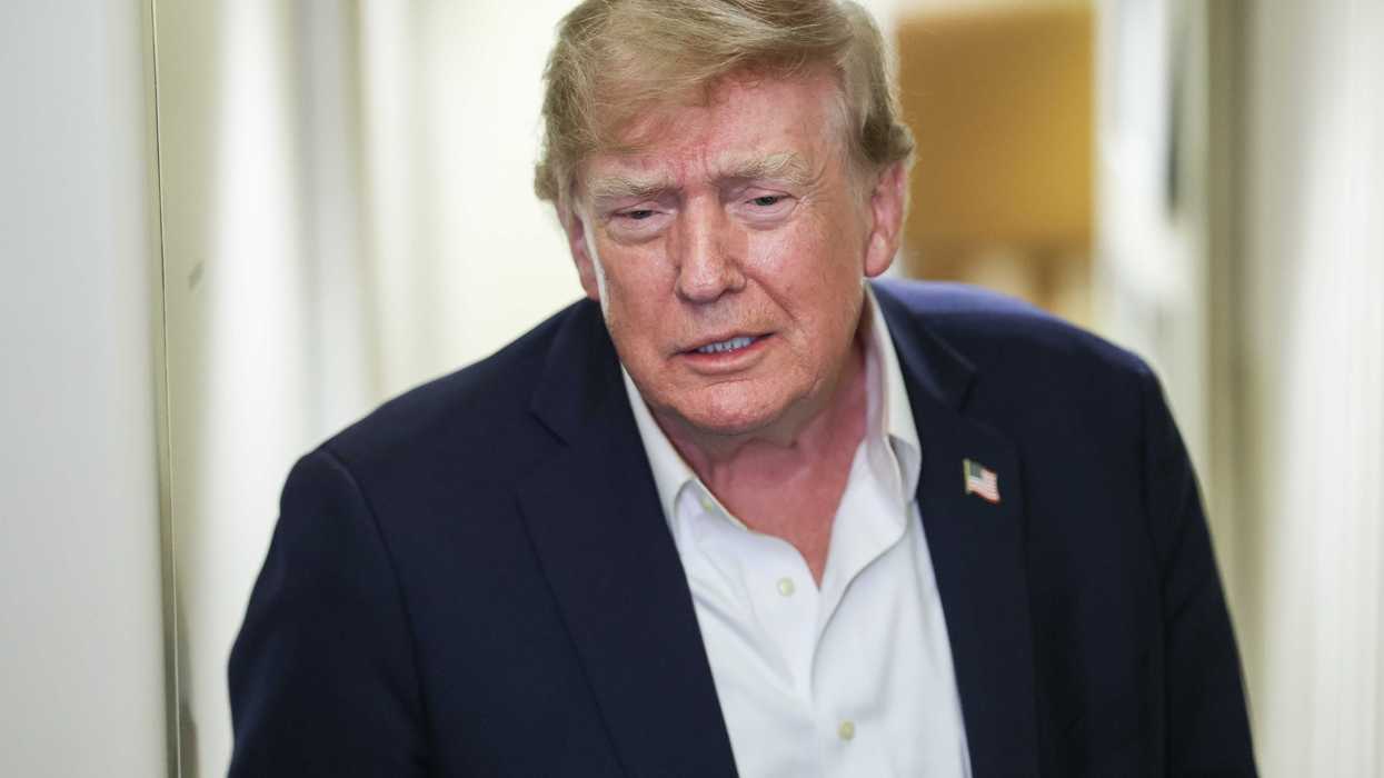 Donald Trump talks to reporters on board Air Force One.