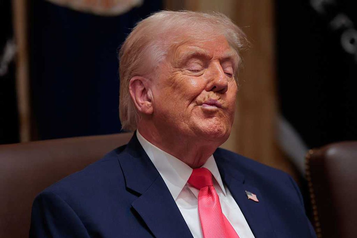 Donald Trump twists his mouth while listening to officials at a cabinet meeting.