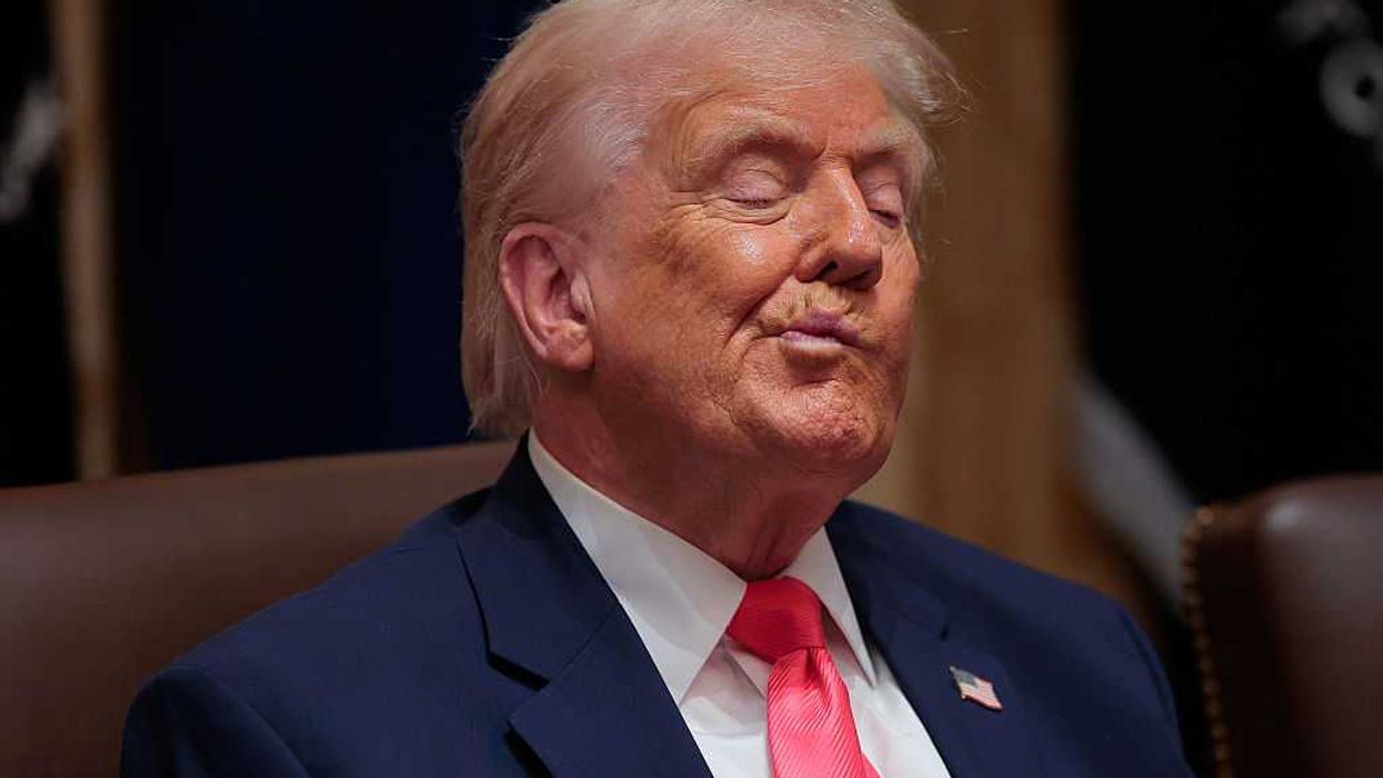 Donald Trump twists his mouth while listening to officials at a cabinet meeting.