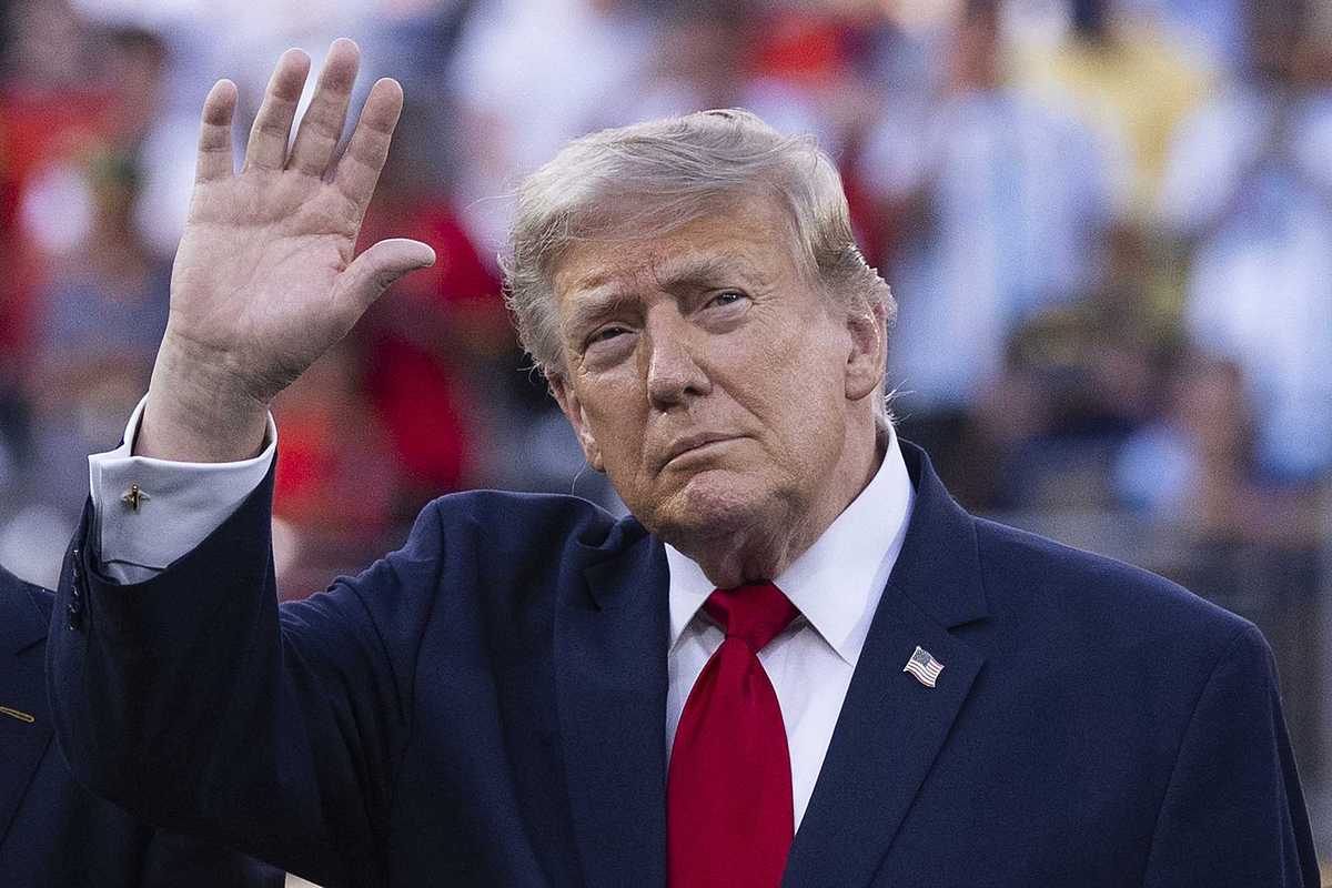 Donald Trump waves at the crowd at the World Cup final.