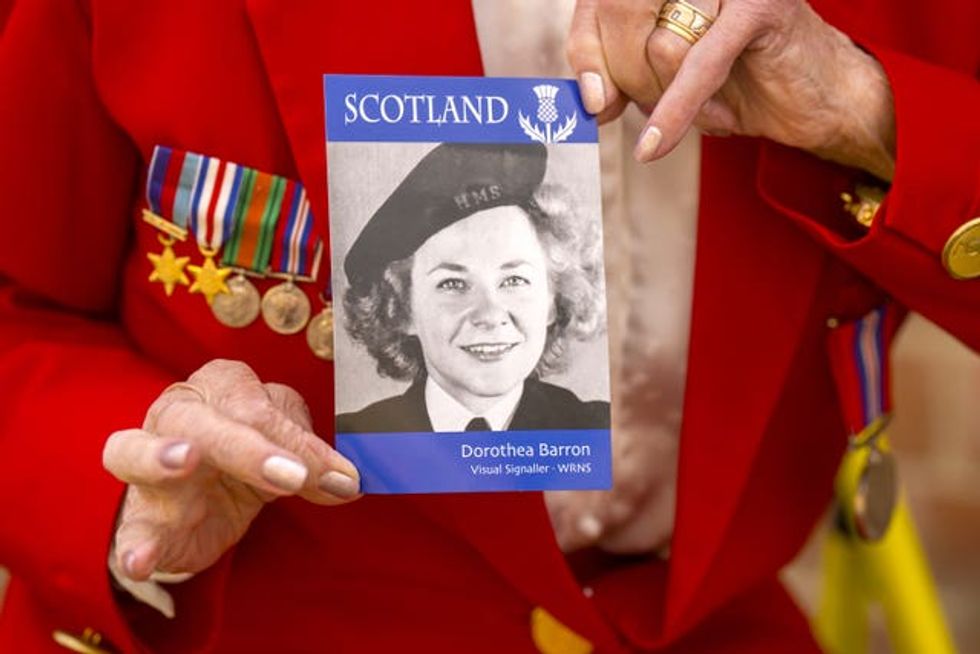 Dorothea Barron, 100, holds a picture of herself taken in 1943
