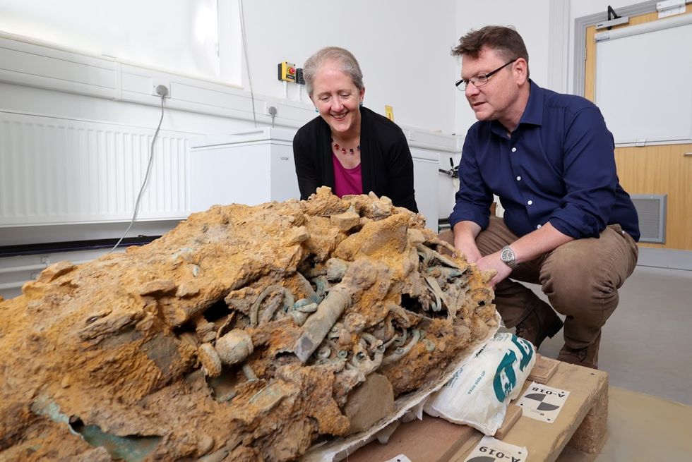 Dr Emily Williams and Professor Tom Moore examine a block of tangled Iron Age artefacts corroded together found in Melsonby