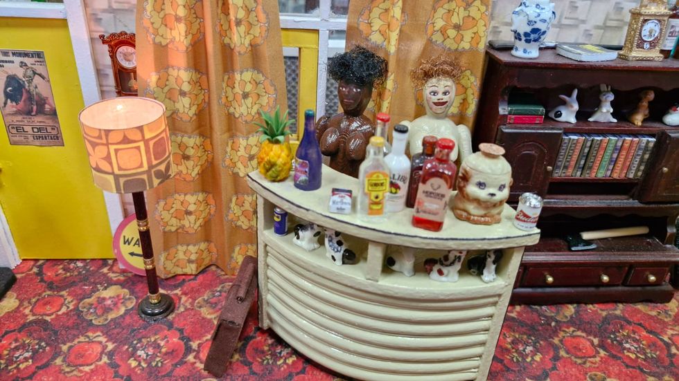 Drinks bar with blow-up dolls in background