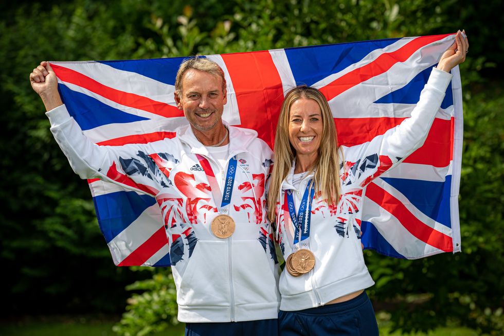 Dujardin and team mate Carl Hester raise the Union flag in celebration of their medal wins in Tokyo (Ben Birchall/PA)