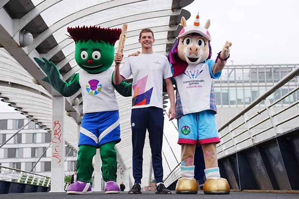 Duncan Scott with the Commonwealth mascots Clyde and Finnie next to him
