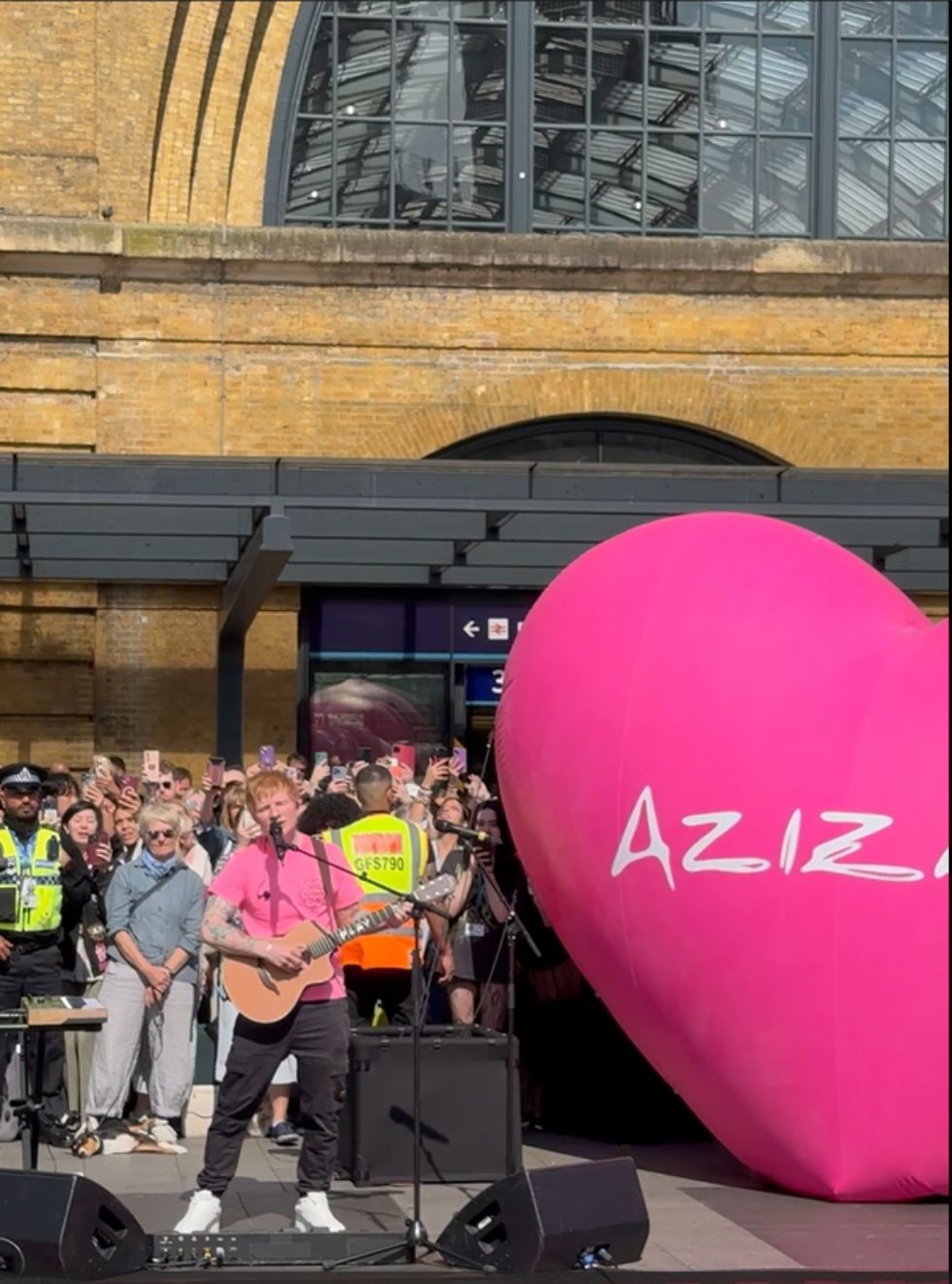 Ed Sheeran performing outside of King's Cross station
