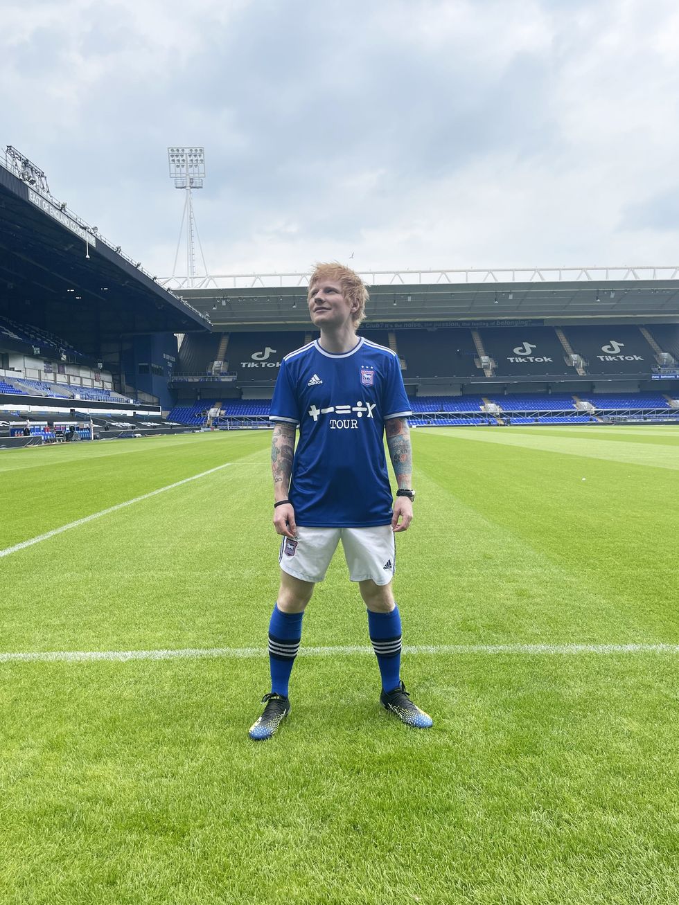 Ed Sheeran wearing one of three signed Ipswich Town Football Club 2021/22 home football shirts he donated (LD Communications/PA)