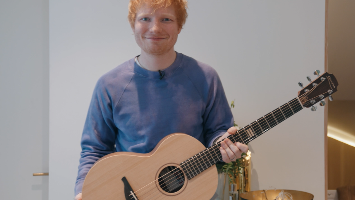 Ed Sheeran with the prototype Equals guitar that he has donated as the prize in a charity raffle (GeeWizz/PA)