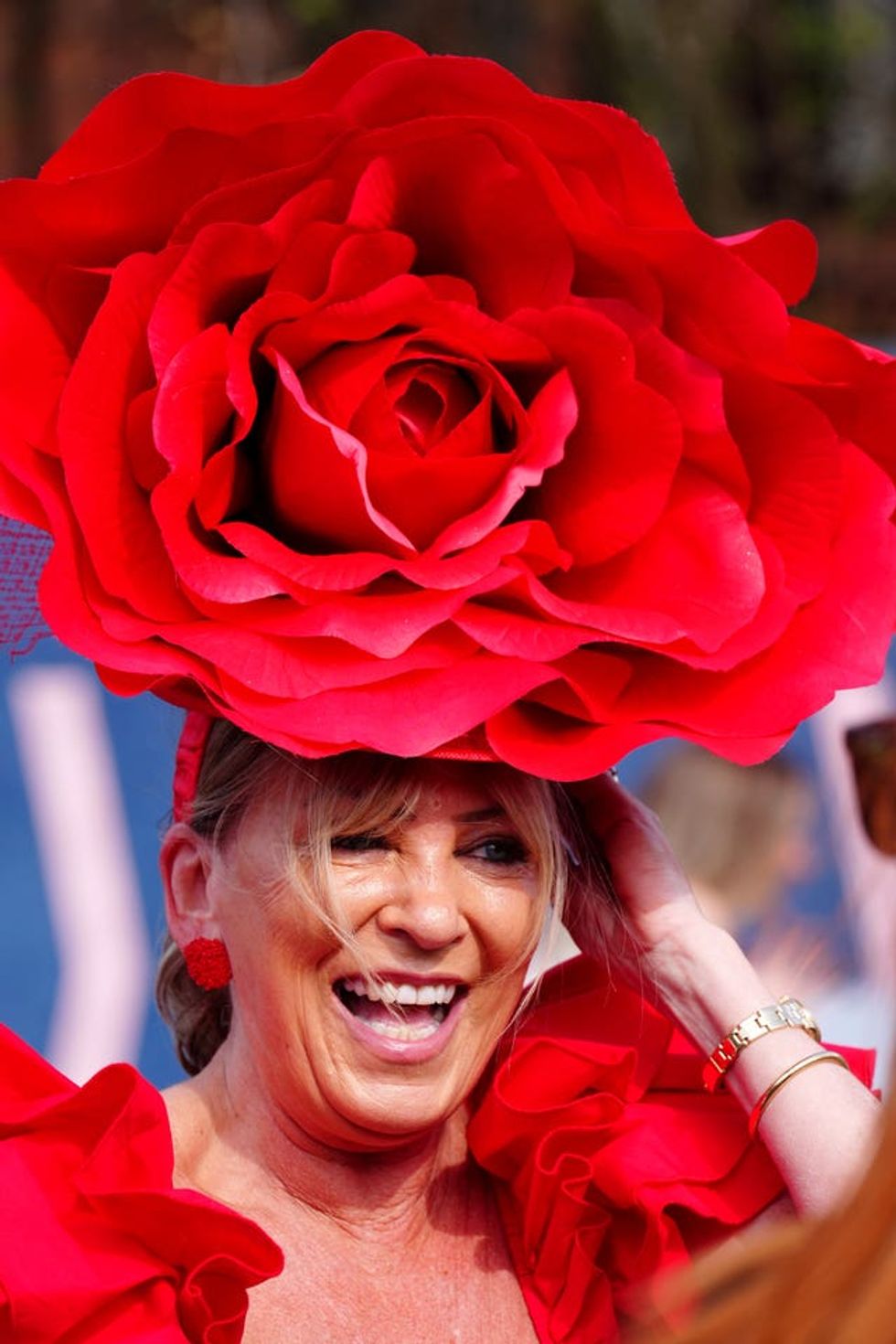 Eilish Waters wearing a large red rose-shaped fascinator