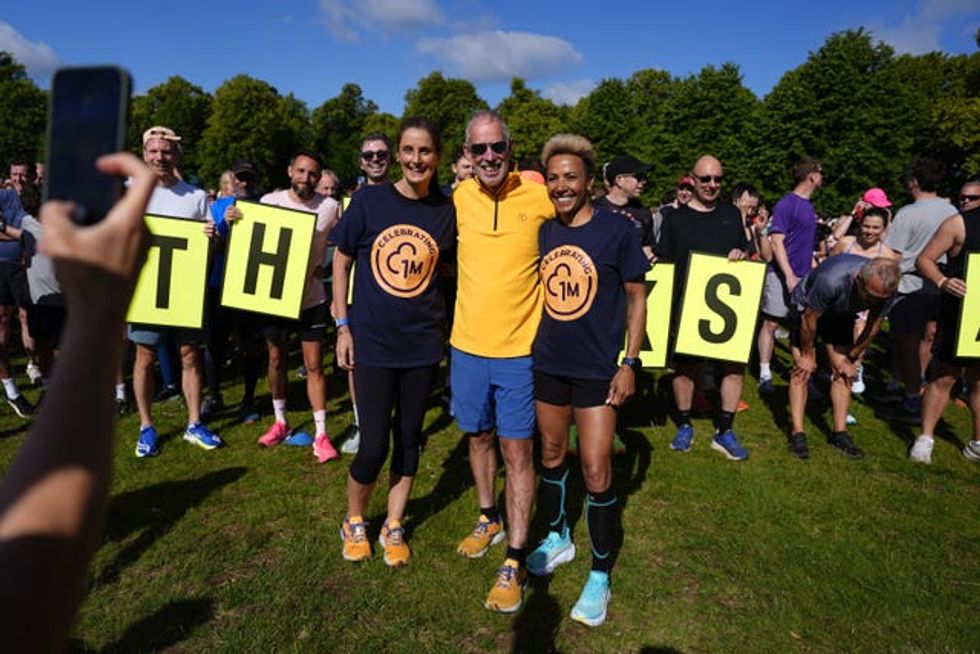 Elizabeth Duggan, chief executive officer of parkrun Global (centre left) Parkrun founder, Paul Sinton-Hewitt (centre) and Dame Kelly Holmes (centre right) at the Bushy Park Parkrun in London