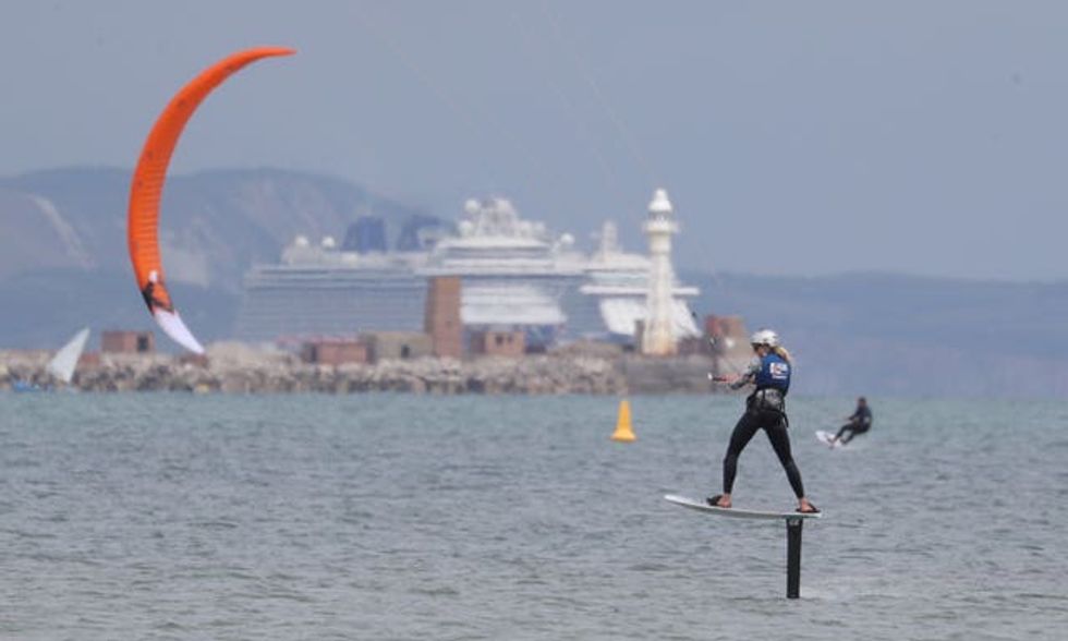Ellie Aldridge on her kite board during a training session in Portland harbour