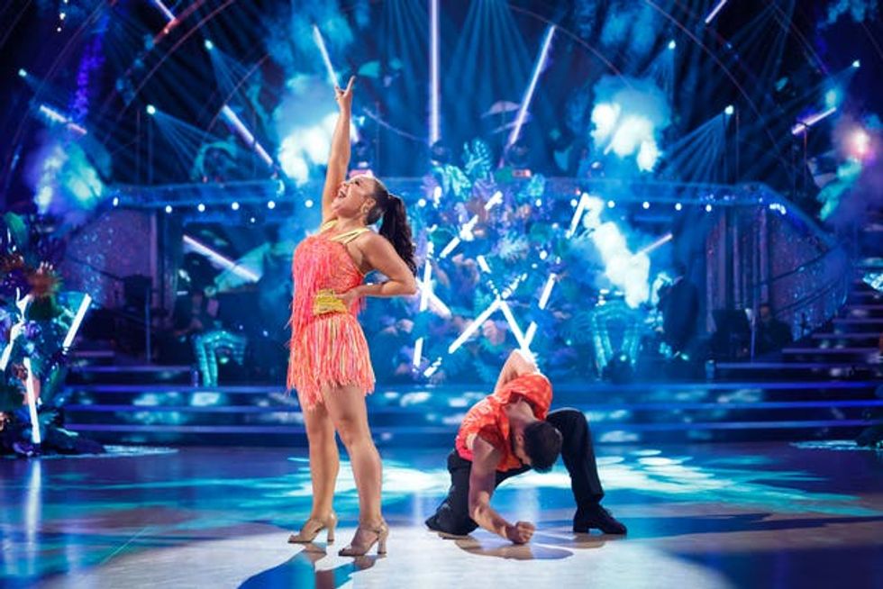 Ellie Leach reaches upwards as Vito Coppola kneels on the floor as part of their dance