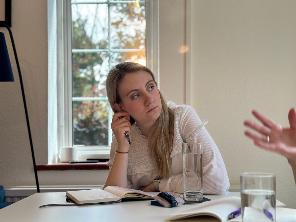 Ellie Vesey-Thompson sitting at a table