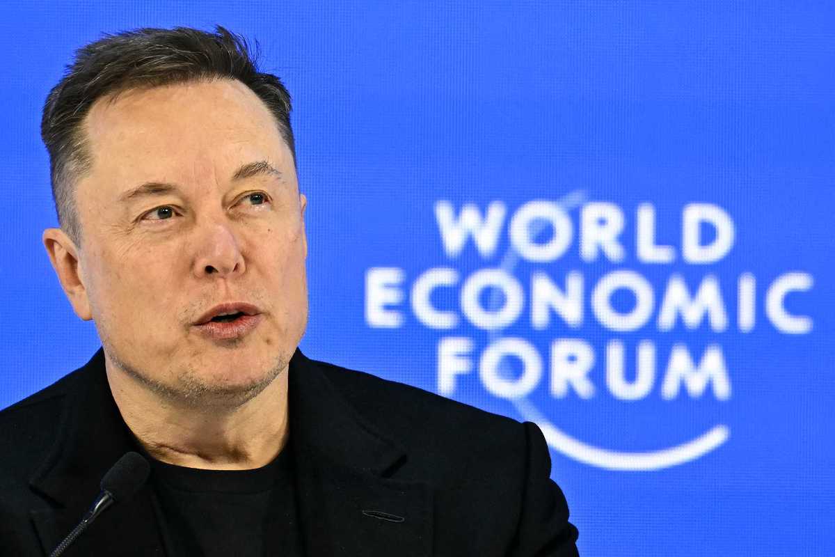 Elon Musk, a white man with sort black hair, speaking at the World Economic Forum.