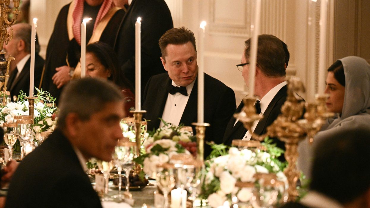 Elon Musk chats to another guest at a White House dinner.