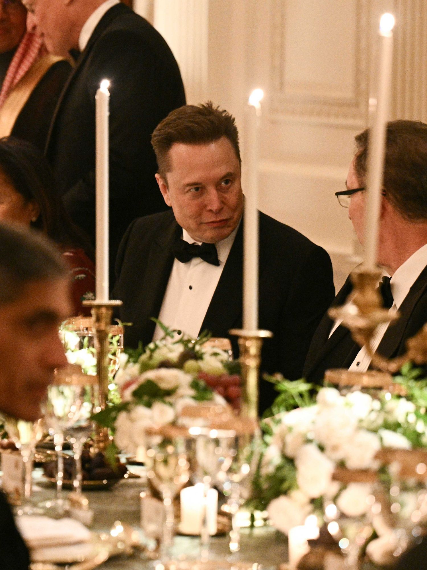Elon Musk chats to another guest at a White House dinner.