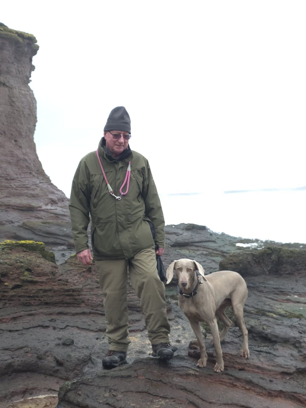 (Embargoed until Saturday 2 May at 00:01) Sparkles the dog was rescued by North Berwick RNLI and Coastguard. The picture shows owner David Hall and Sparkles before the incident. (Credit David Hall)