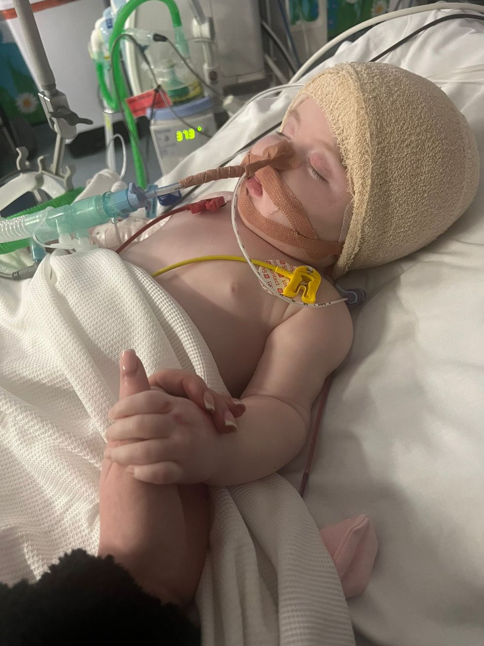 Baby diagnosed with brain tumour aged three months celebrates birthday at home