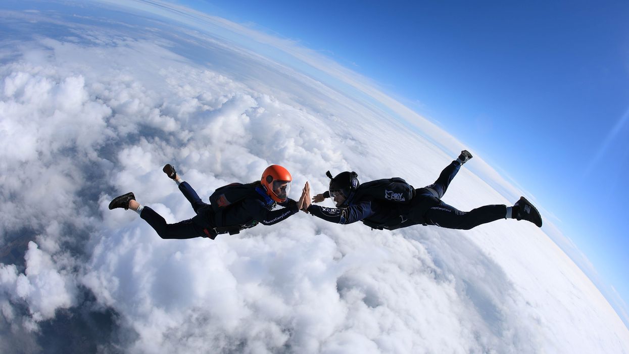 Emily Aucutt and Josh Carratt during their skydiving high five record attempt