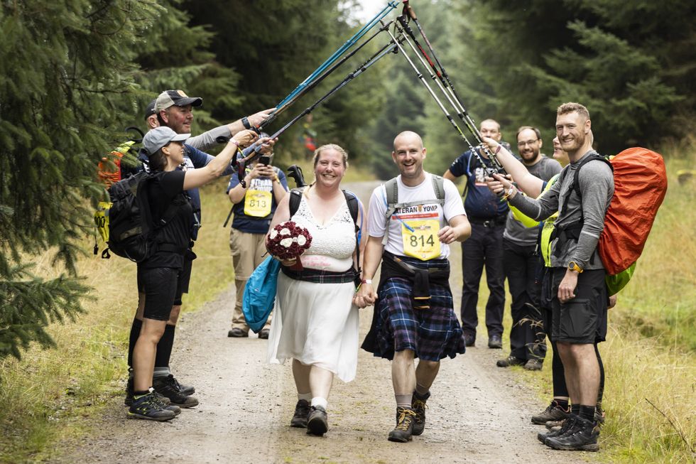 Emma Adams took part in her wedding dress, with husband Andy in his kilt (Chris Walker/ABF)
