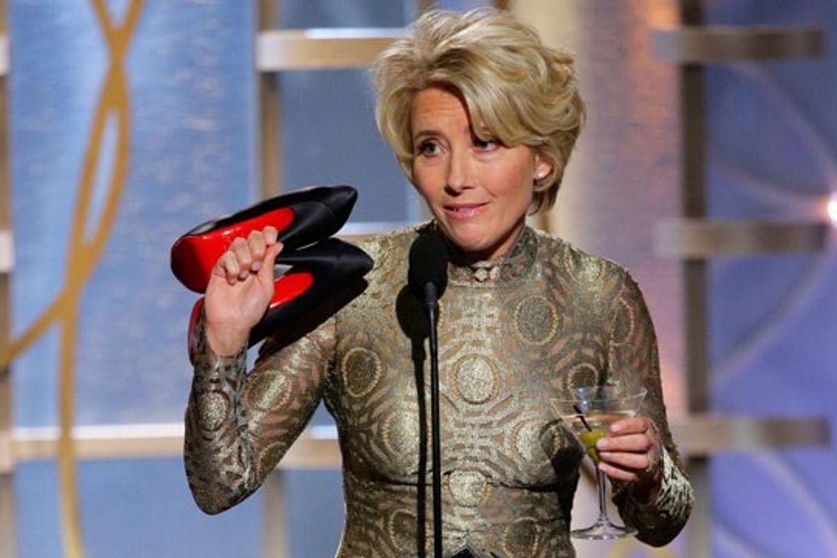 Emma Thompson holds a martini in one hand and her heels in the other on stage at the Golden Globes