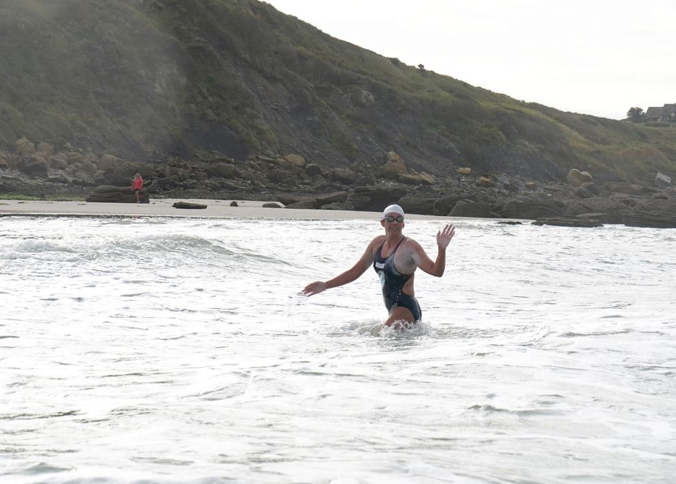 Endurance swimmer Chloe McCardel comes ashore near Pointe de la Courte Dune on the French coast after a gruelling 10-hour swim from Kent (Gareth Fuller/PA)