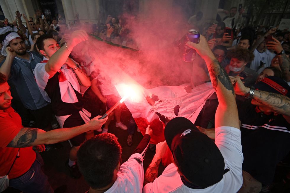 England fans burn an Italian flag in central London