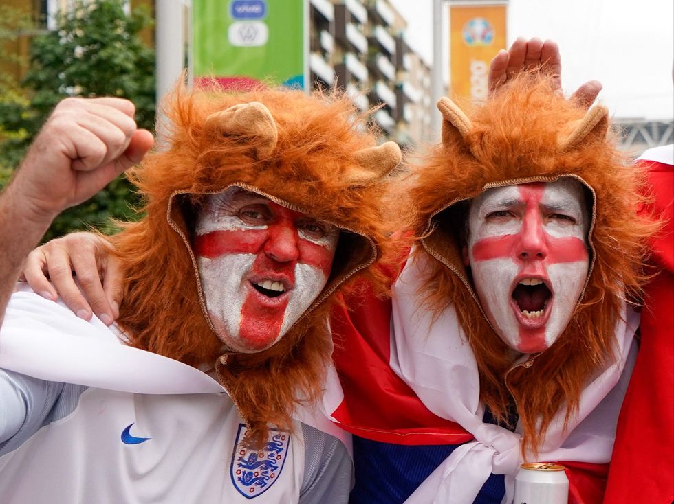 England fans pose outside the stadium ahead of the game