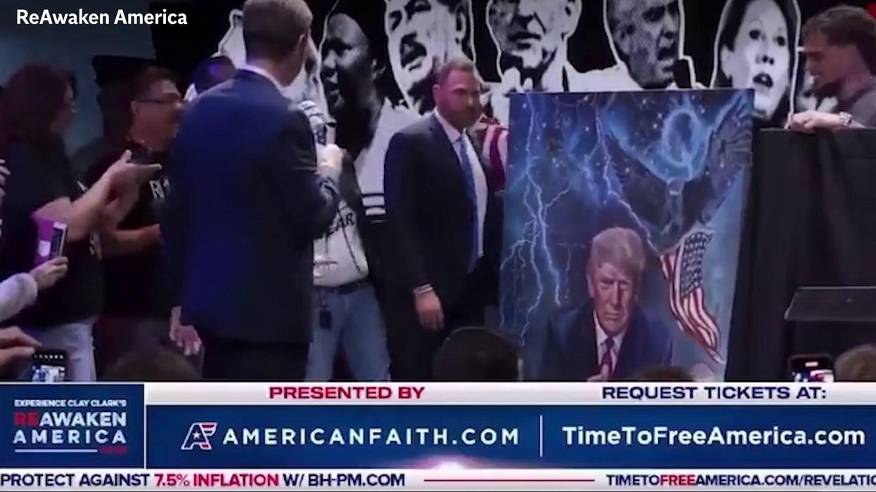 ‘I love that!’: Eric Trump accepts ‘Q’ painting of his father at controversial conference