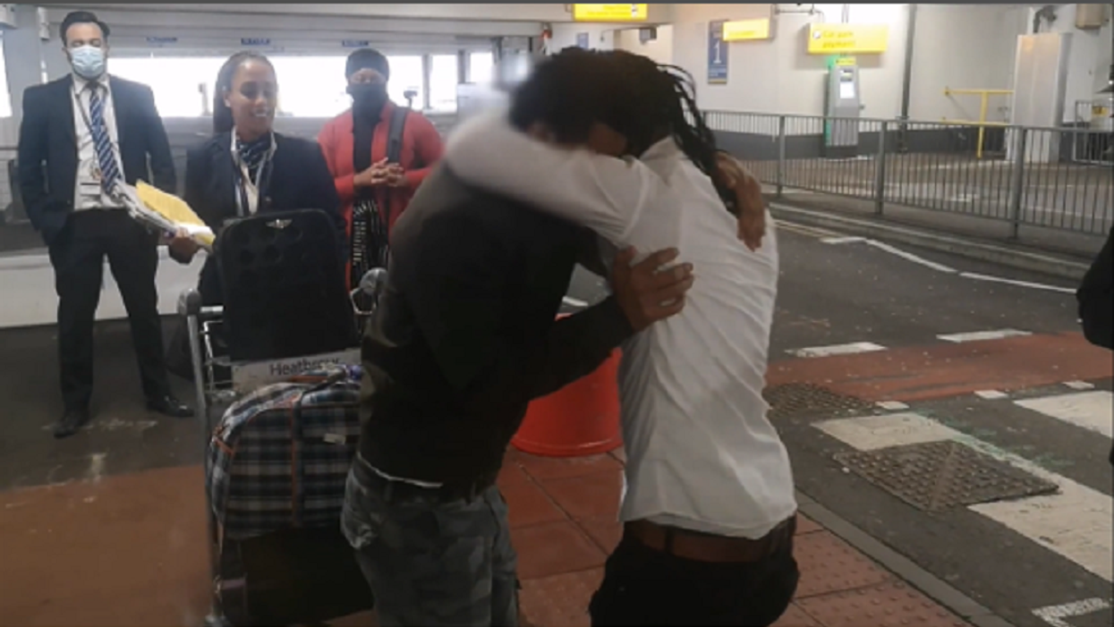 Eritrean teenage brothers Adi and Eyob hugging after being reunited at Heathrow Airport (Da’aro Youth Project/Benny Hunter/PA)