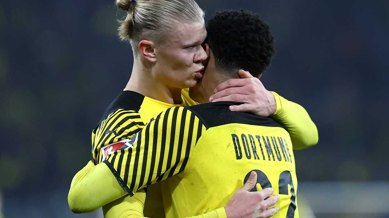 Erling Haaland of Borussia Dortmund celebrates scoring his teams first goal of the game with team mate Jude Bellingham by giving him a kiss during the Bundesliga match between Borussia Dortmund and SpVgg Greuther Fürth at Signal Iduna Park on December 15, 2021 in Dortmund, Germany