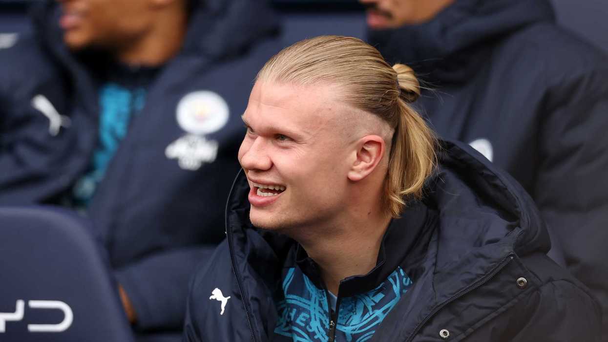 Erling Haaland of Manchester City laughs, as he looks on from the substitutes bench prior to the Premier League match between Manchester City and Crystal Palace at Etihad Stadium on May 13, 2026 in Manchester, England