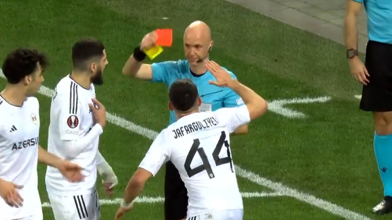 Awkward moment footballer tries to high-five ref to avoid red card