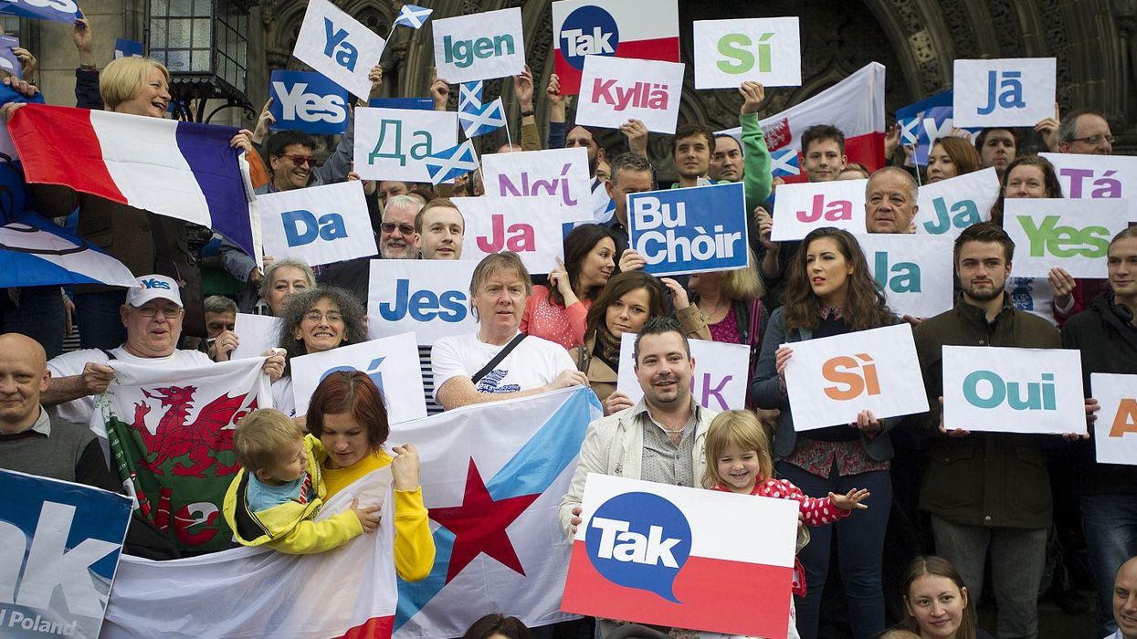 European citizens hold leaflets in different languages in Edinburgh on 9 September 2014