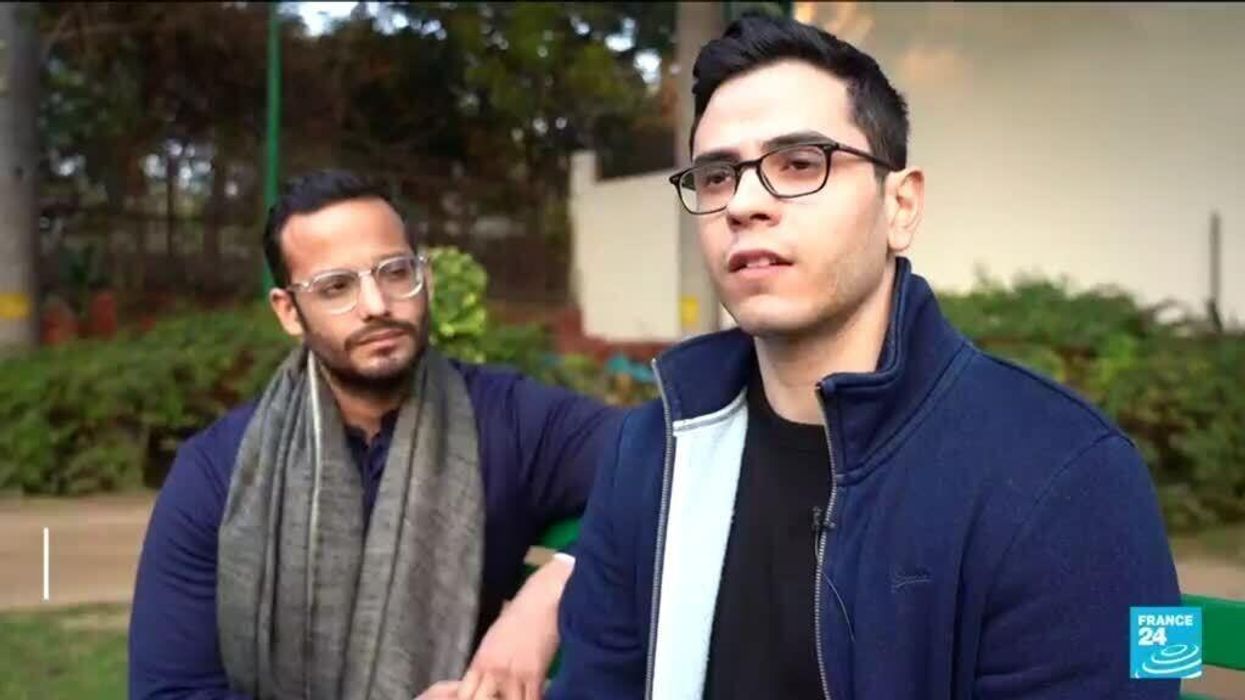 Gay couple sprayed with 'holy water' after they hugged in public