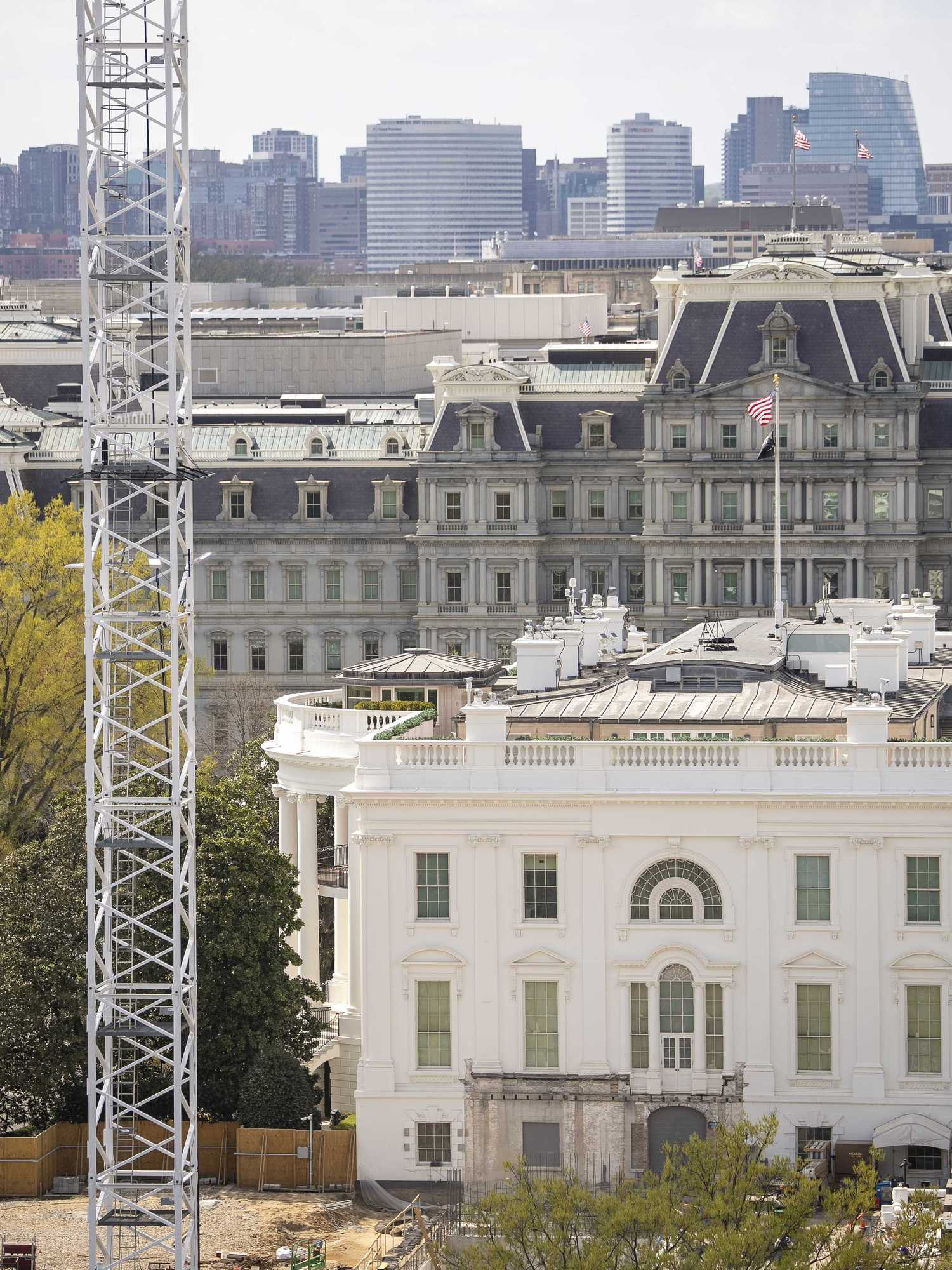 Exterior of the White House with a giant crane to the left of it.