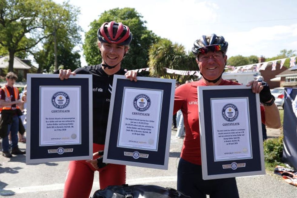Father and son holding their certificates for three Guinness World Records after a charity cycle