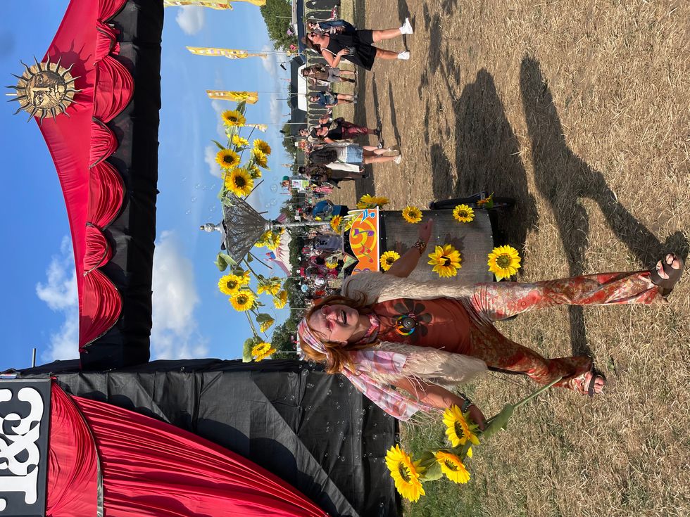 Festival goer with sunflower printed bike at Glastonbury