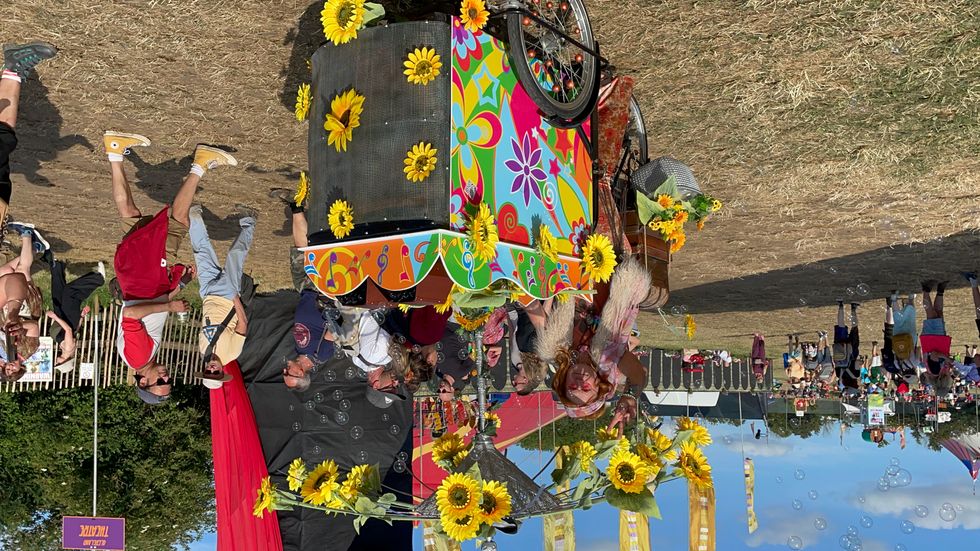 Festival goer with sunflower printed bike at Glastonbury